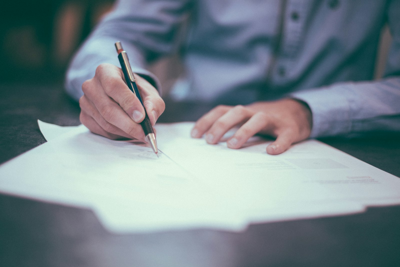 Hands reviewing business documents on a desk